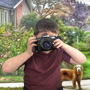 kid-photographer child looking thru an camera taking a picture